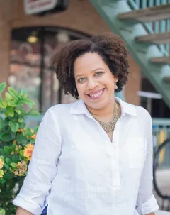 Francine Sinclair, Tampa mobile notary, smiling outside a storefront